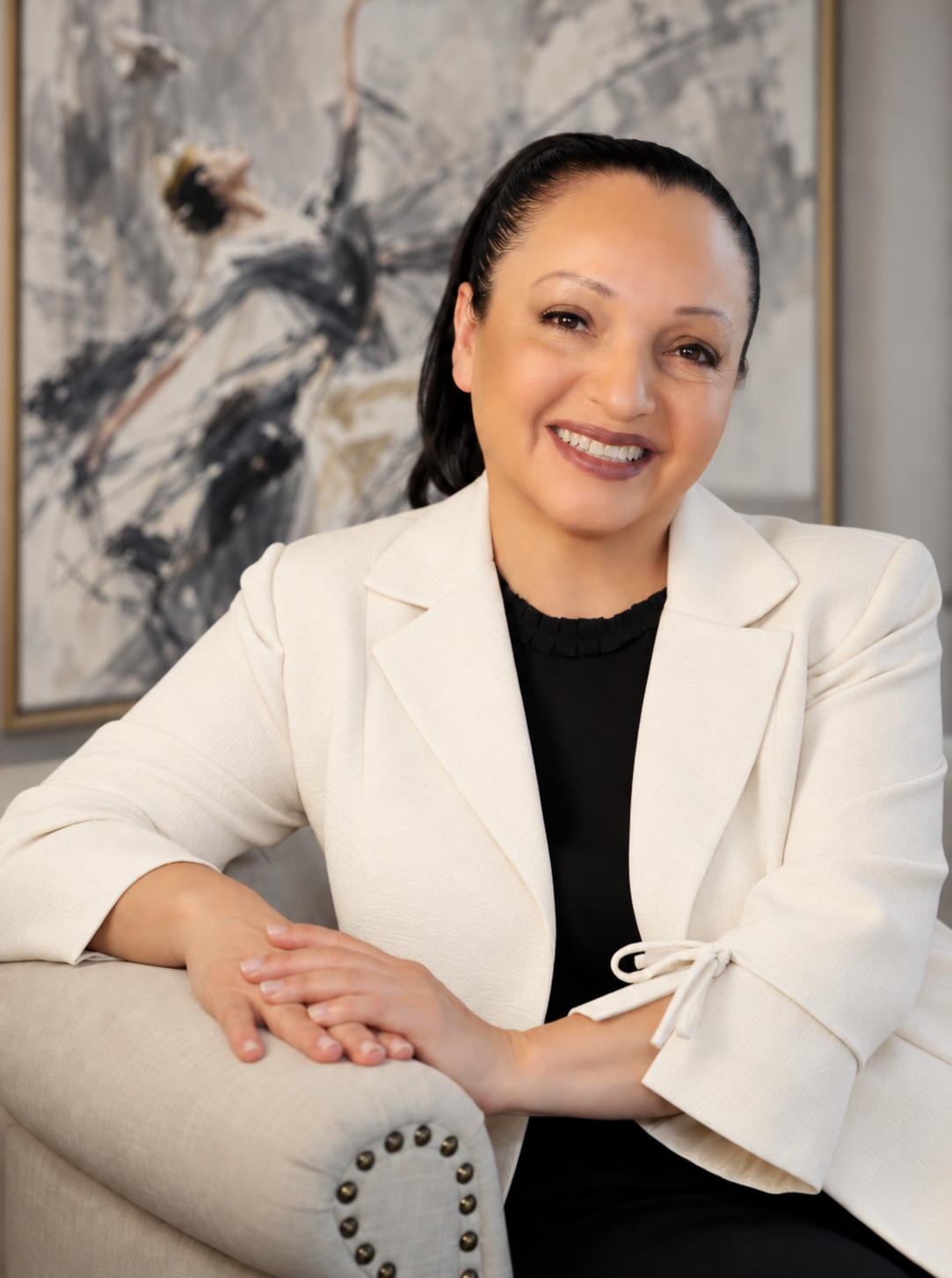 Portrait of Margarita in a white blazer, founder and licensed esthetician since 1999