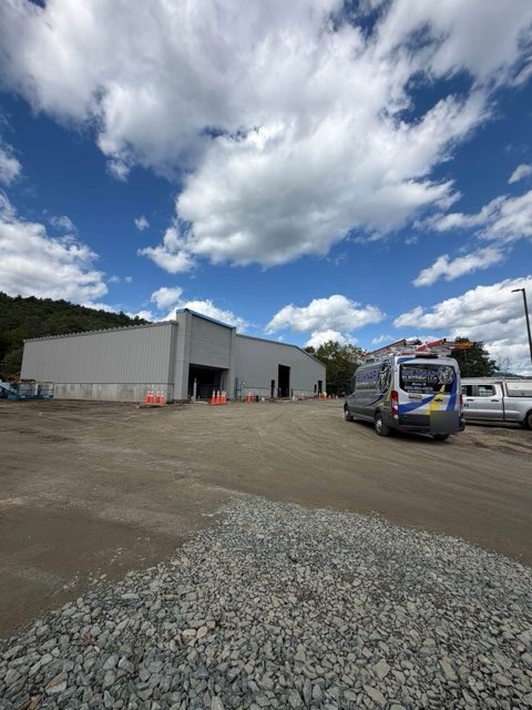 Belknap Electric service van parked at commercial building construction site