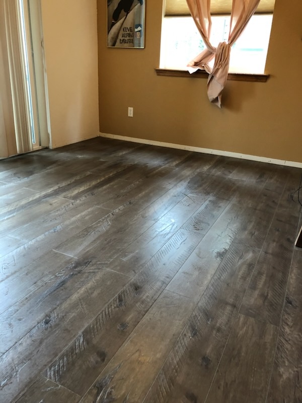 Dark plank composite flooring installed by Bruin Builders