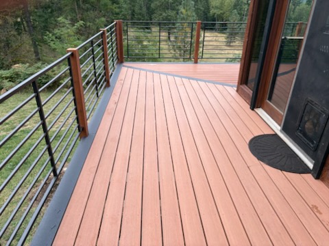 Deck corner with metal railing and wood posts