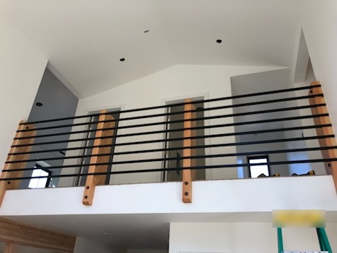 Loft railing with wood posts built by Bruin Builders in North Idaho