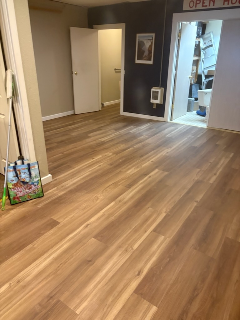 Open room composite flooring install by Bruin Builders