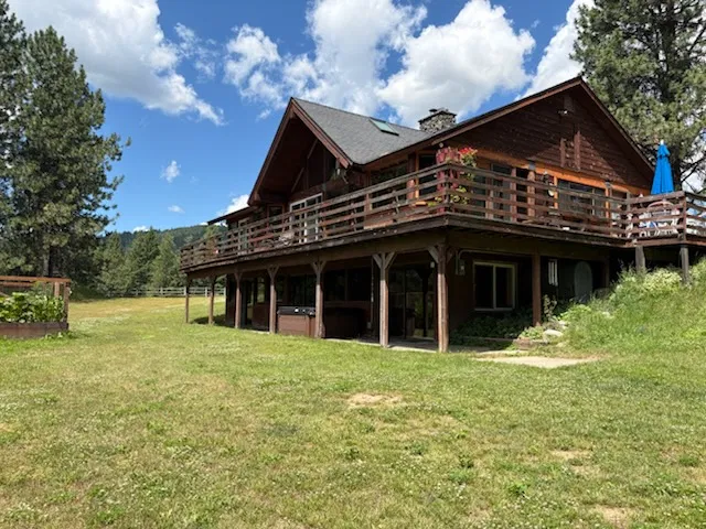 Home exterior before remodel with weathered wood deck and dark exterior