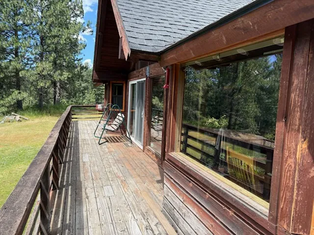 Deck walkway before remodel showing weathered wood and siding