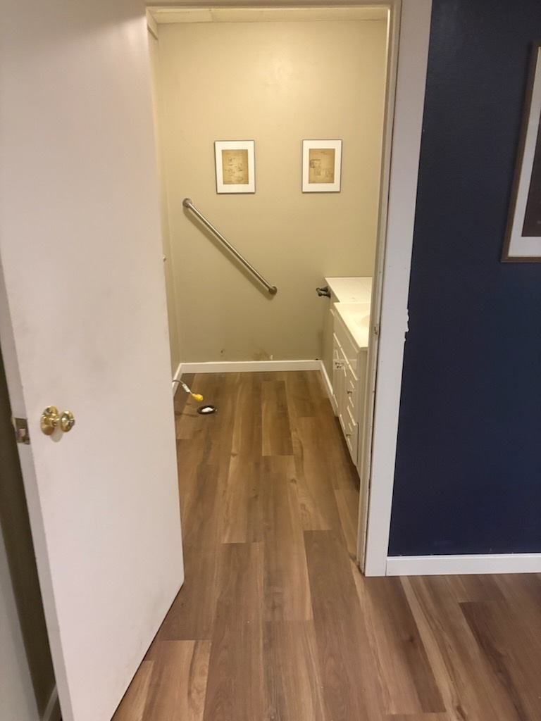 Flooring through hallway to the bathroom by Bruin Builders