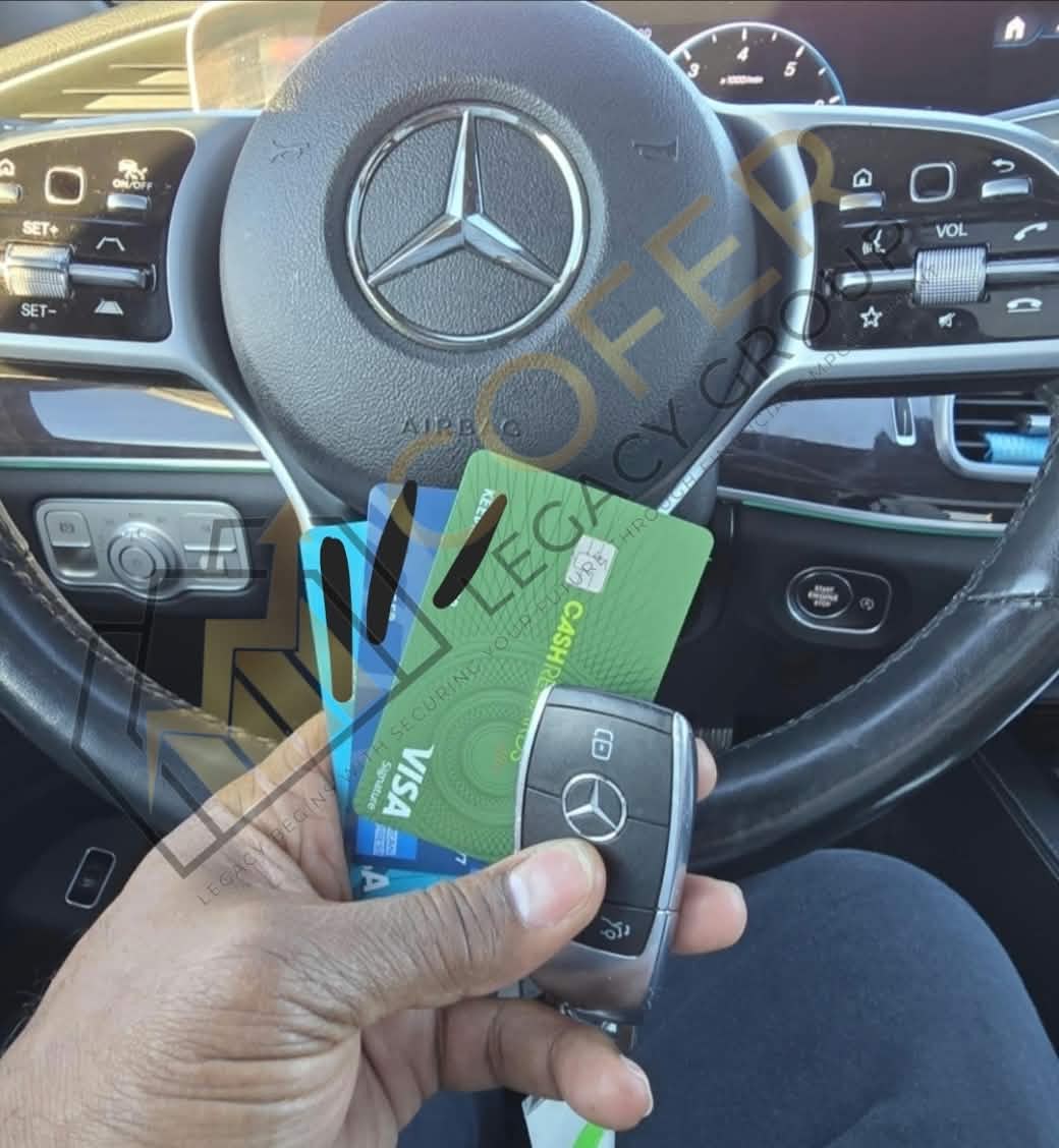 Client holding Mercedes-Benz key fob and approved Visa cards inside their vehicle