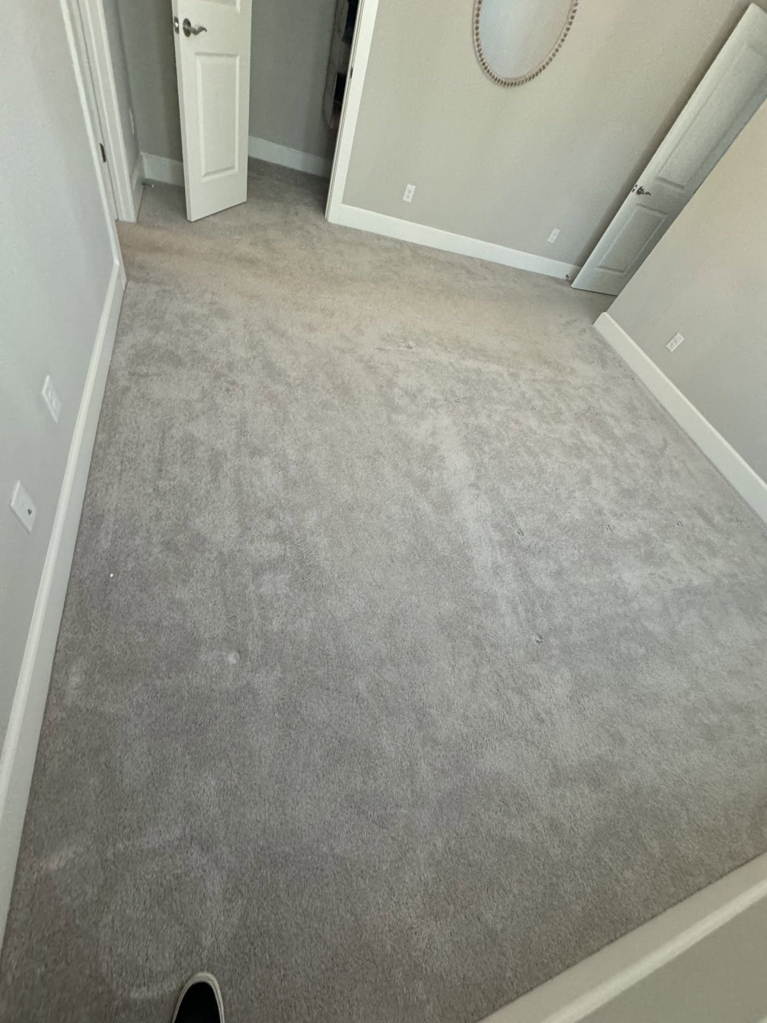 Carpeted room before flooring replacement.