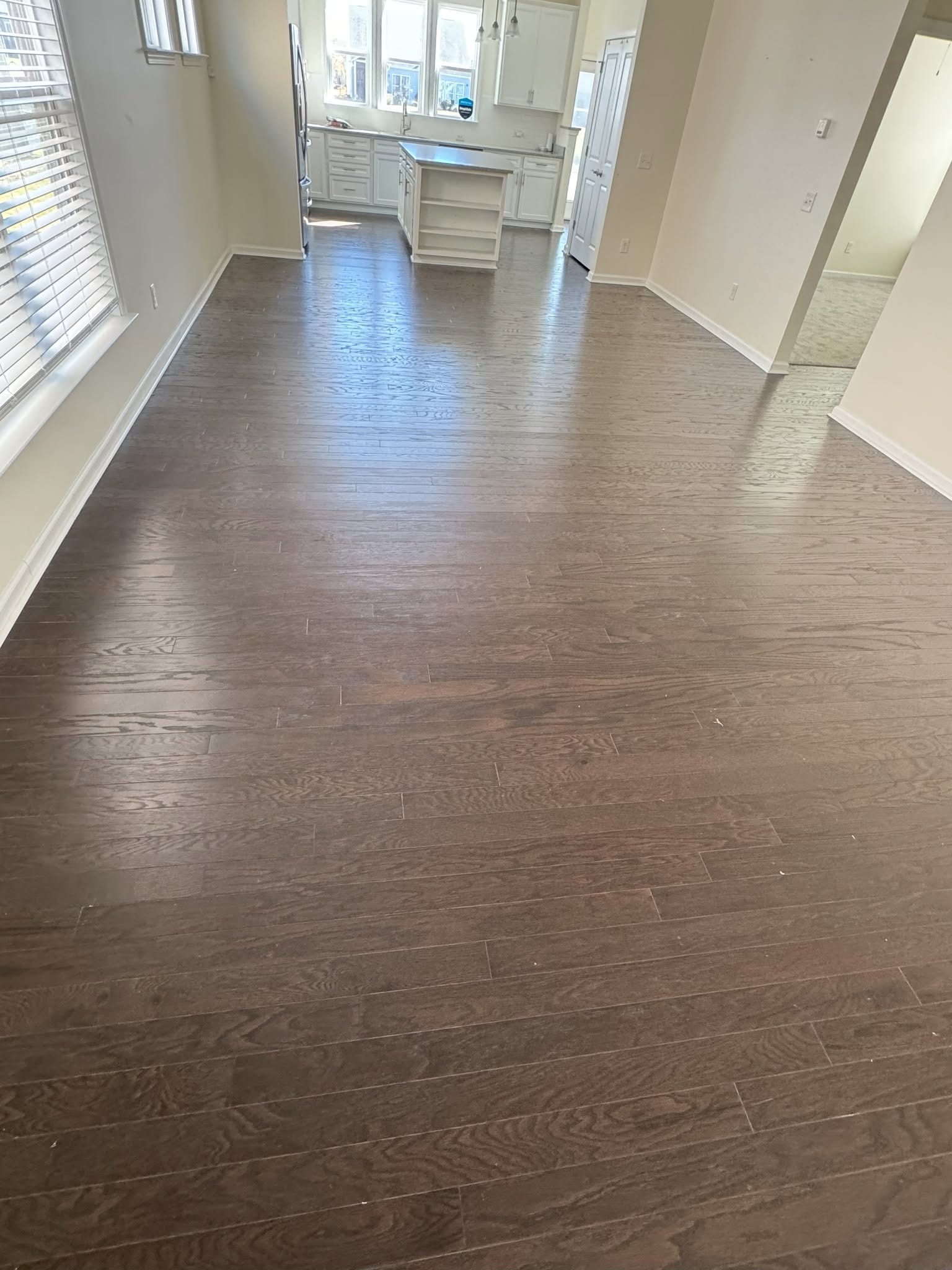 Before: engineered wood flooring toward the kitchen