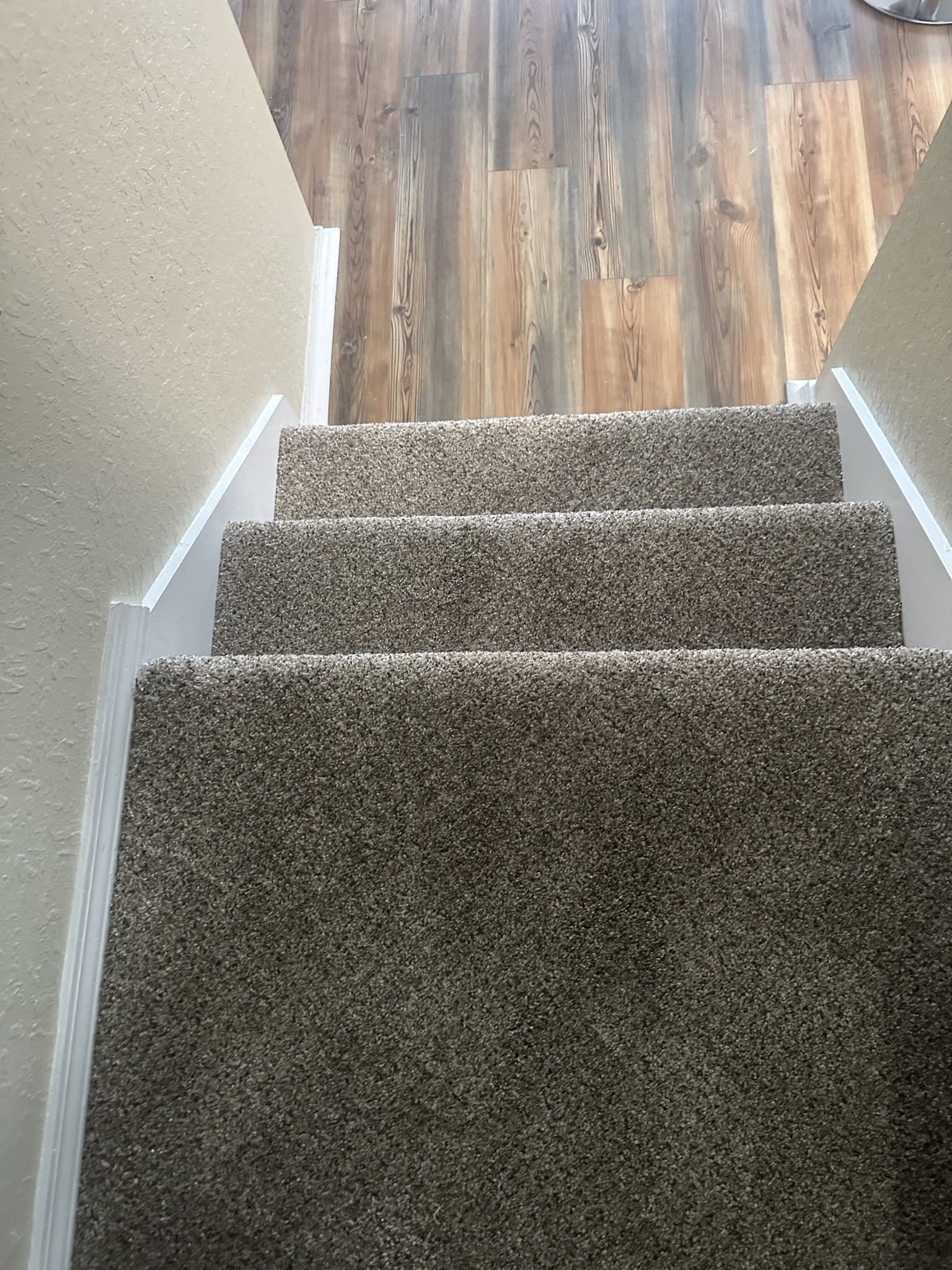 Finished carpet on the landing and lower steps.