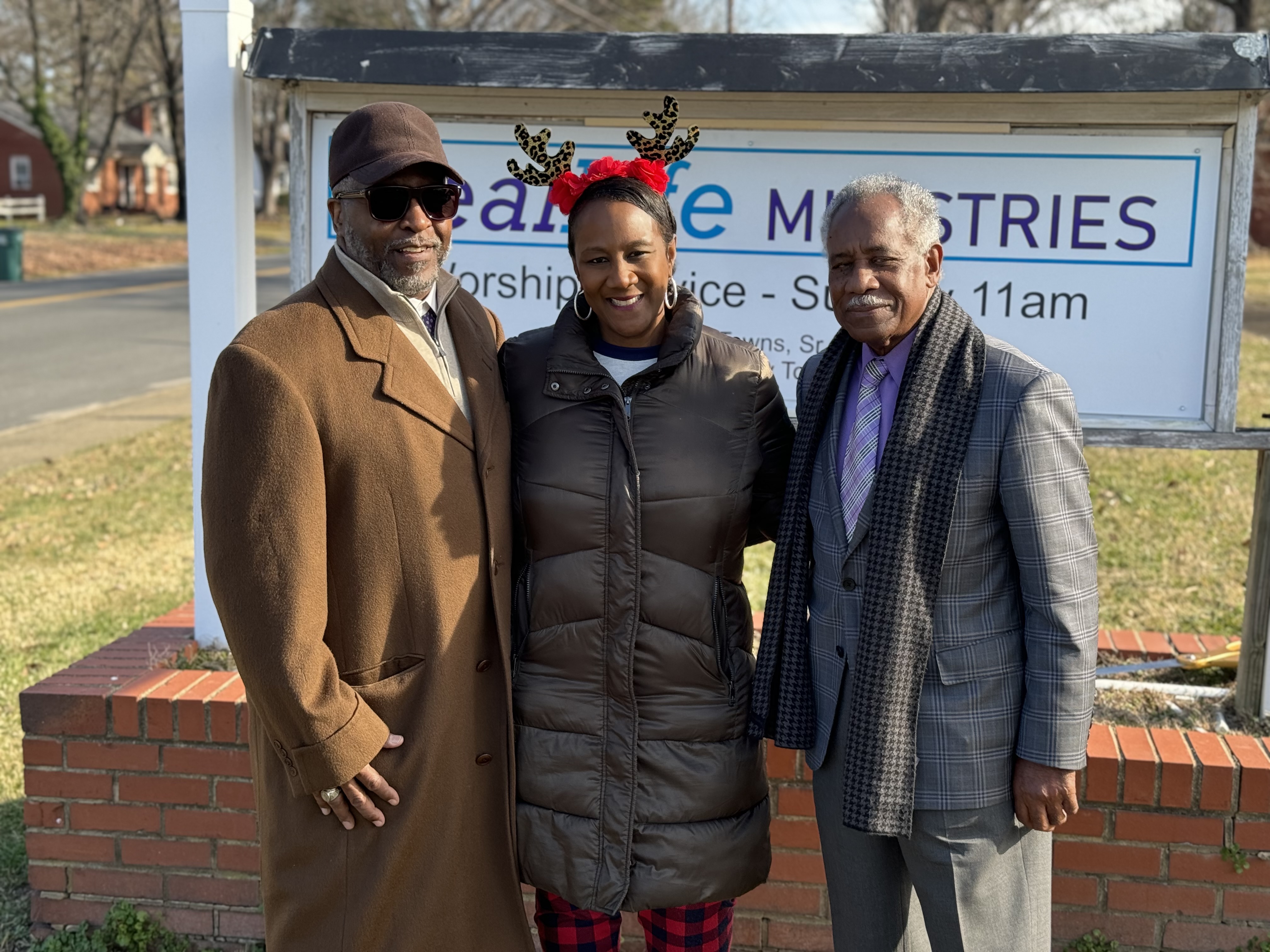 Real Life Ministries church leadership at the welcome sign