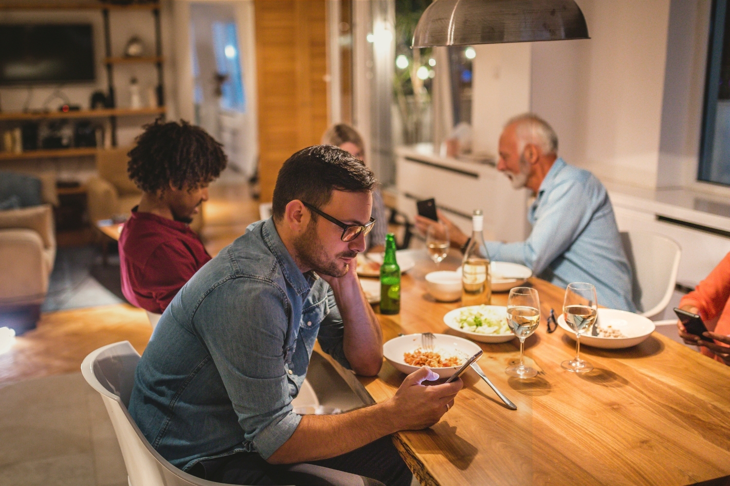 Family dinner where phones keep pulling attention away from the table
