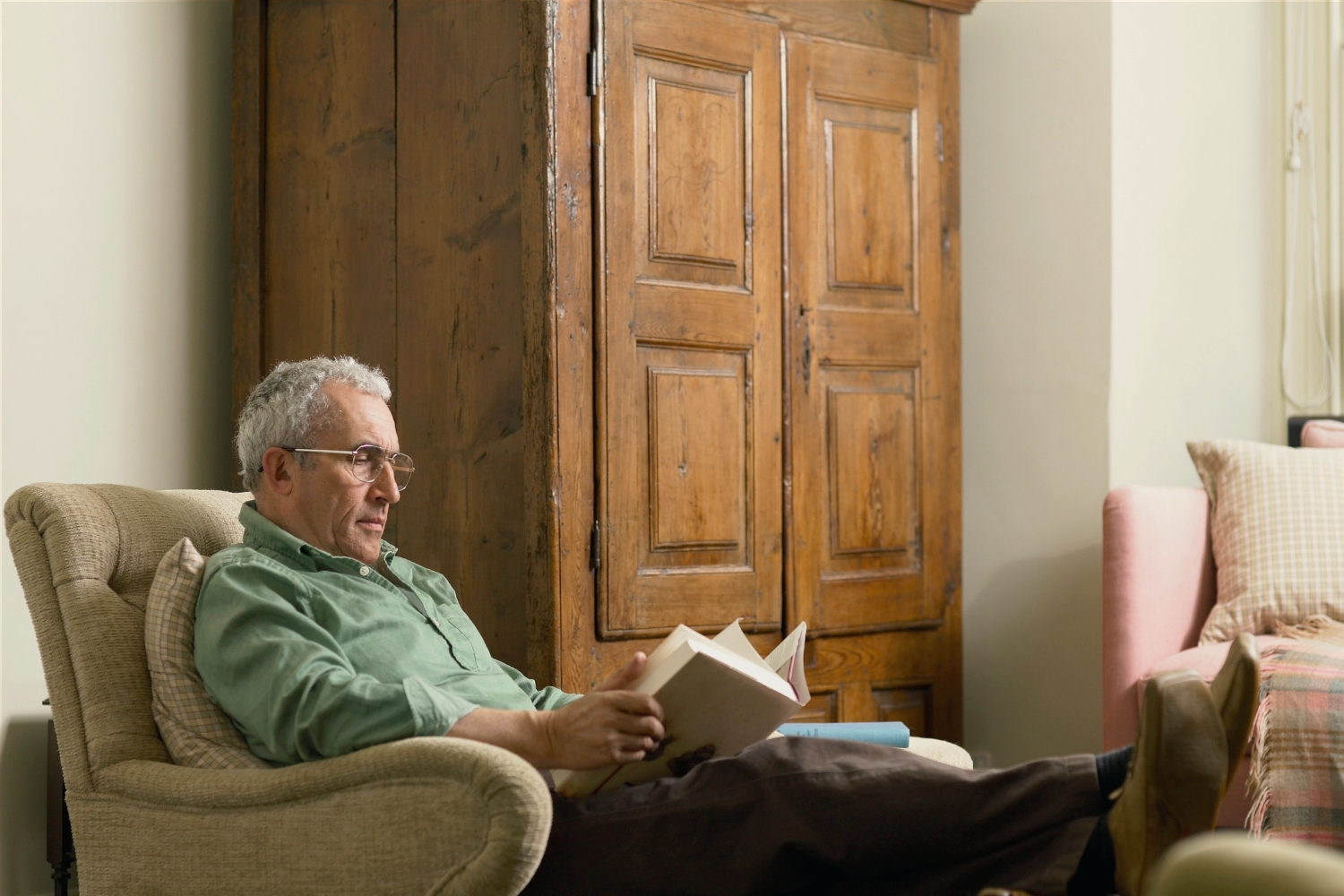 Man reading in his armchair with his feet up