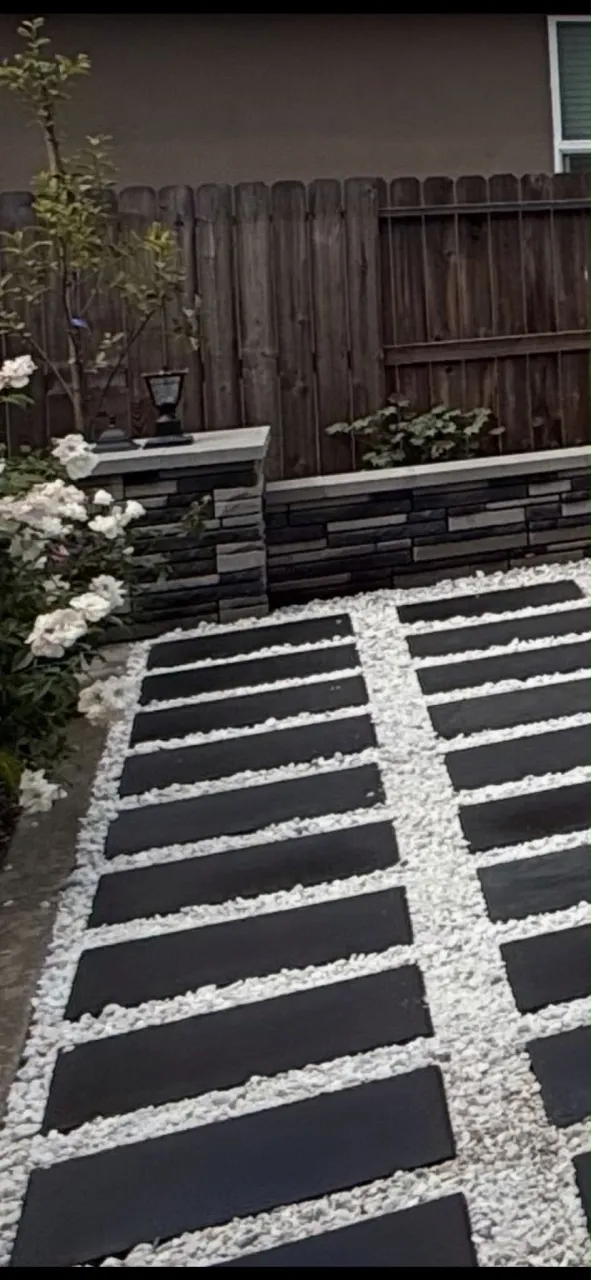 Modern Black Steppers with White Rock & Stacked Stone Wall