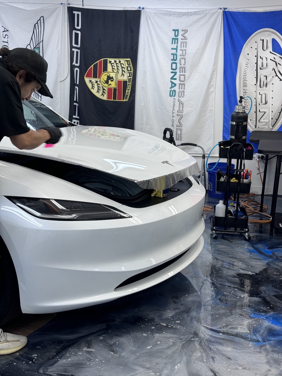 Michael installing SPP Performance Paint Protection Film on a white Tesla hood