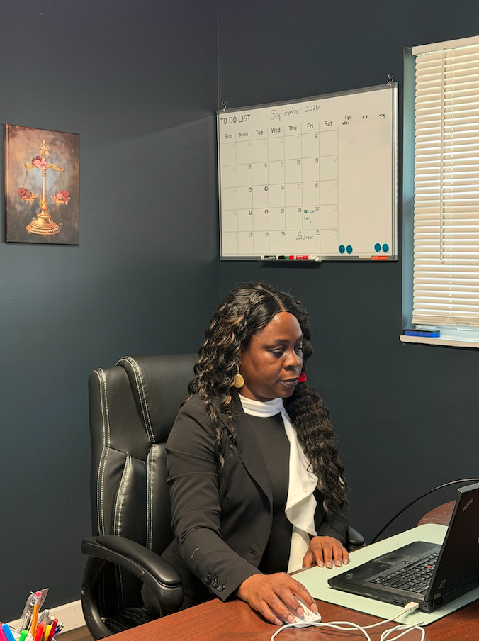 Attorney Esther Oise working on personal injury client case files