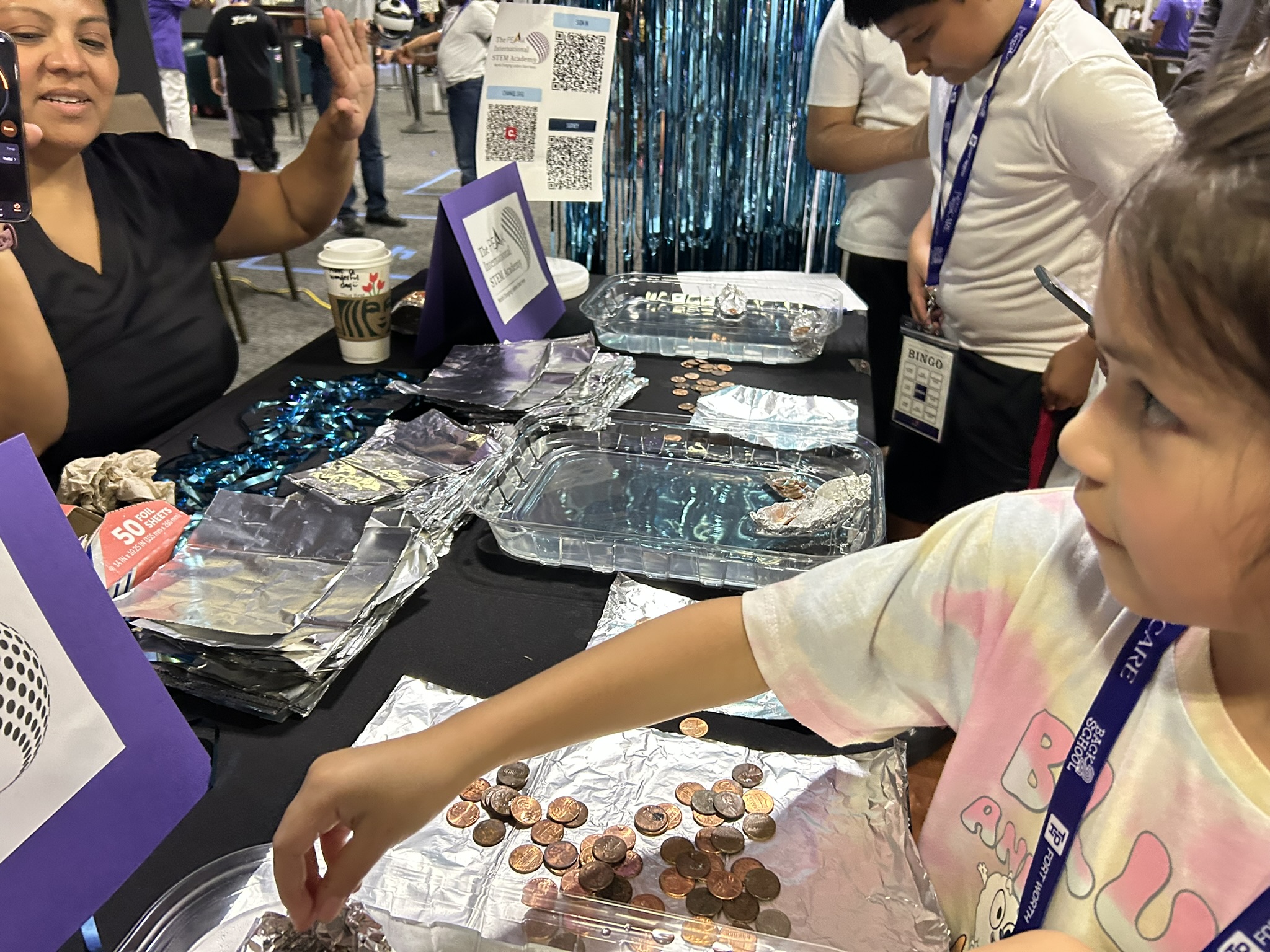 Hands-on water density and foil boat STEM experiment at Back to School Fest, July 19, 2025