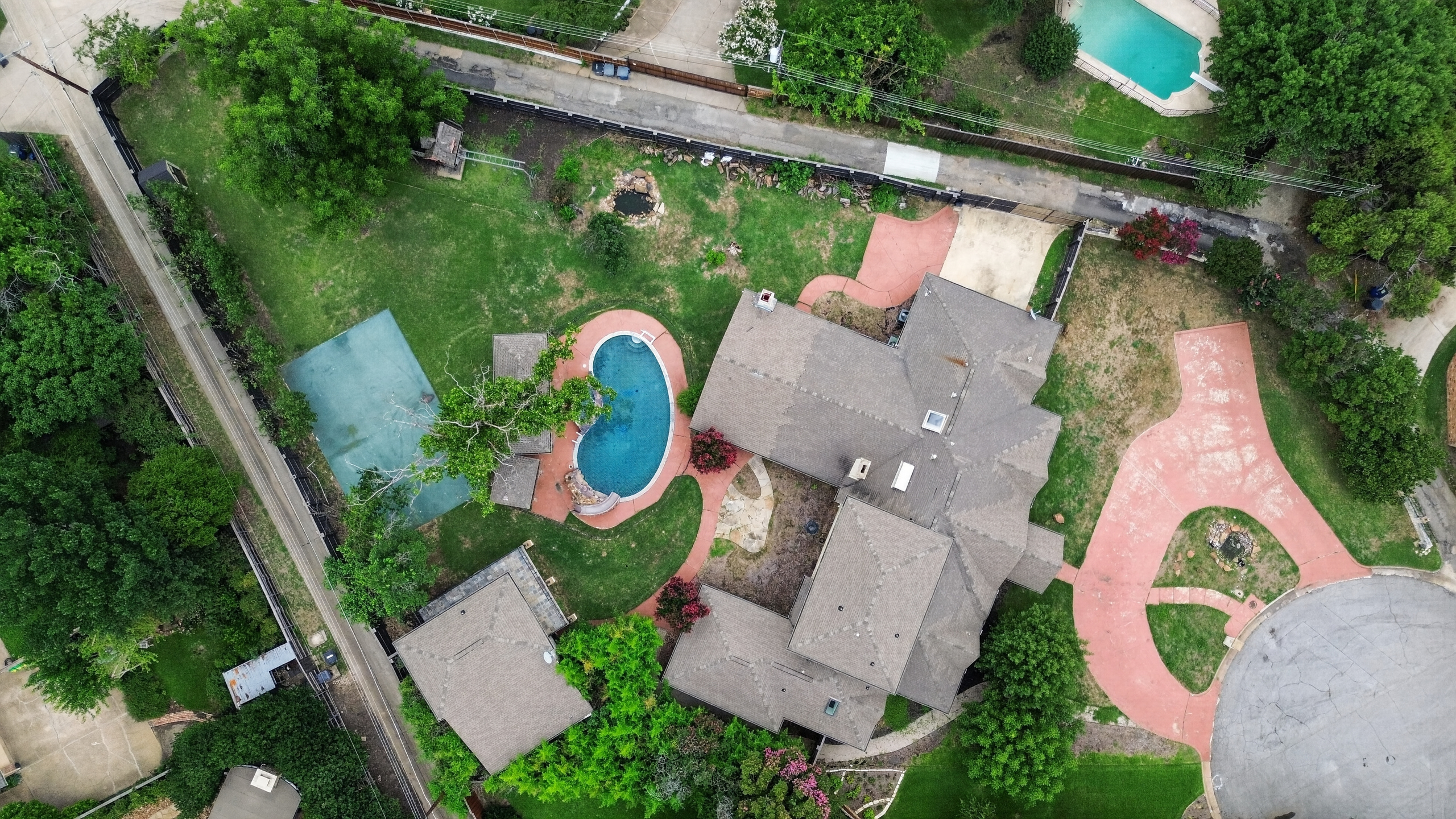 Direct birds-eye aerial overhead showing estate layout, pool, sport court, cedar pavilion, detached casita, circular driveway, and 0.45-acre cul-de-sac grounds