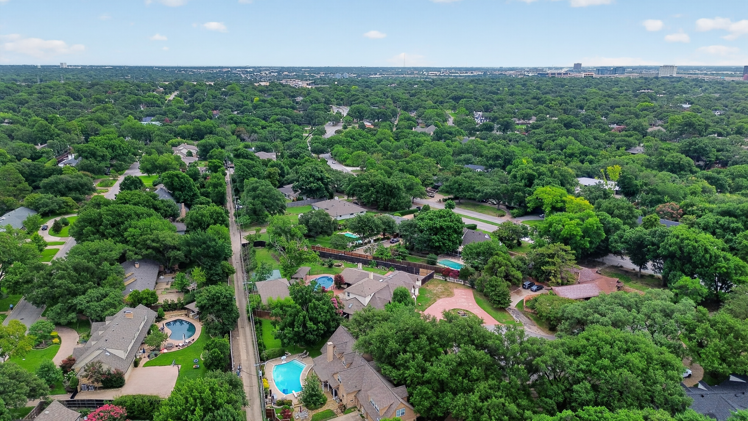 Expansive aerial survey of 0.45-acre secluded lot with mature shade trees and bordering avenues