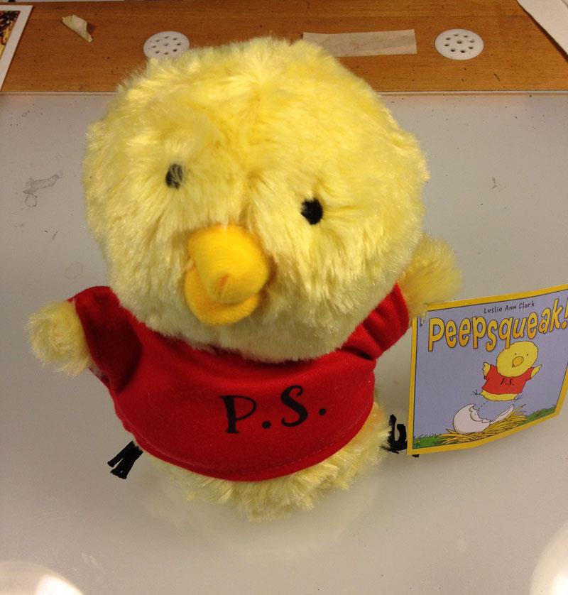 Plush Peepsqueak character toy wearing a red shirt with P.S. and book tag