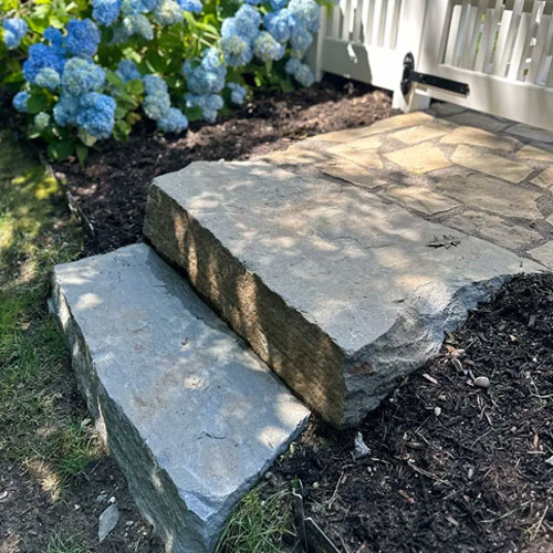 Natural stone slab steps and walkway by IVE Landscaping