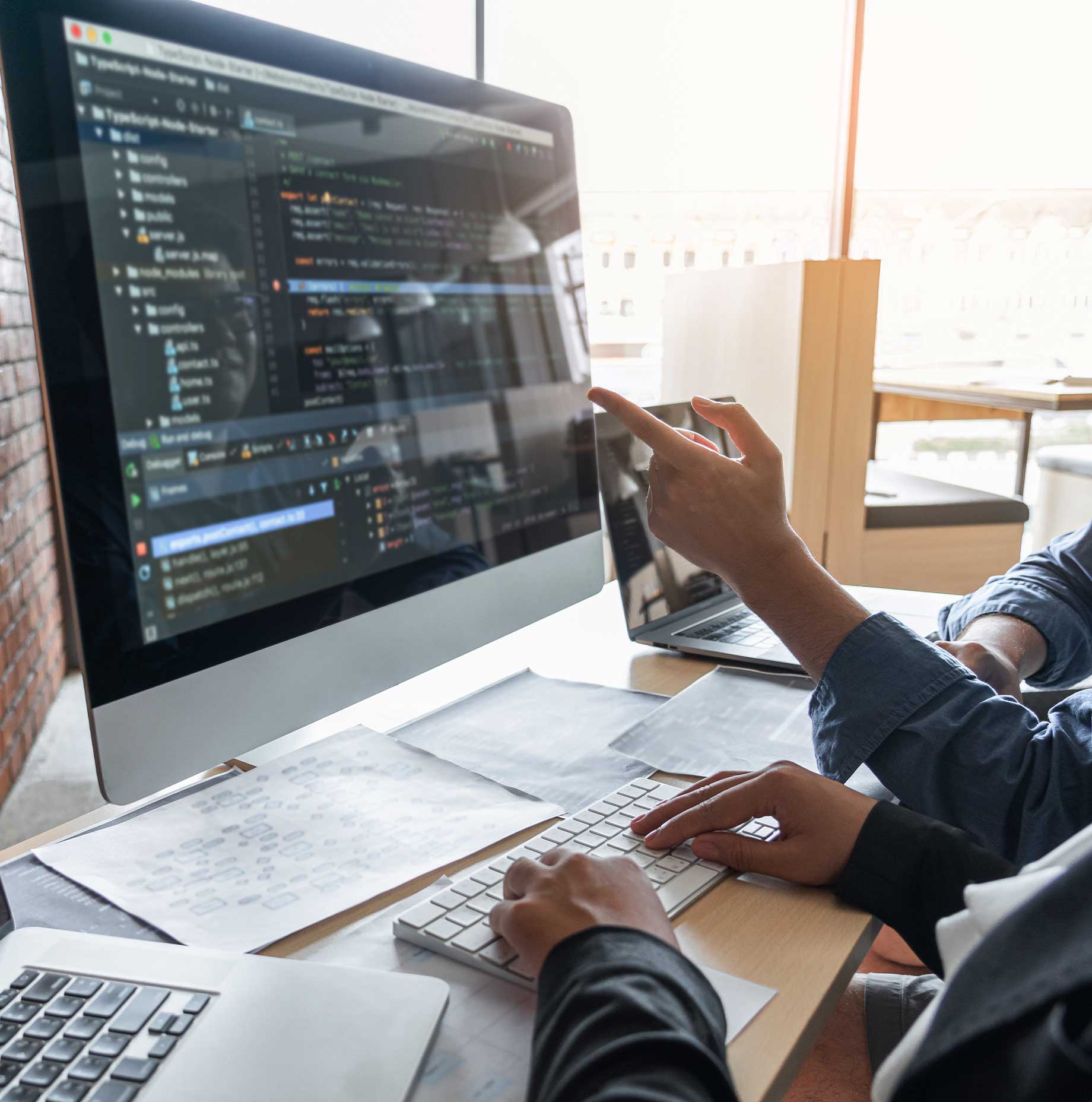 Web designers building a custom website on a desktop computer