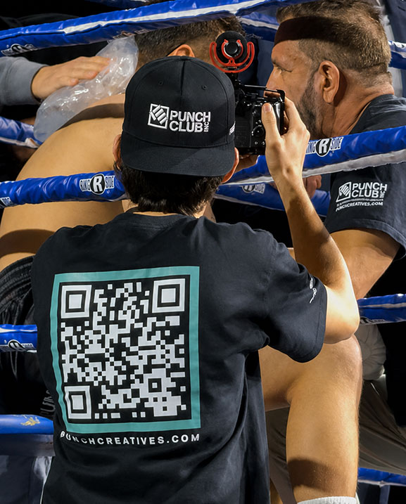 Jose Diaz of Punch Creatives photographing ringside at a boxing match