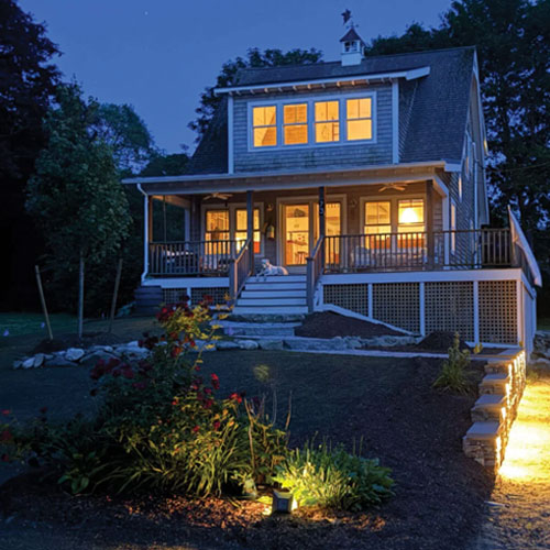 Landscaped front yard with architectural path lighting at dusk by IVE Landscaping
