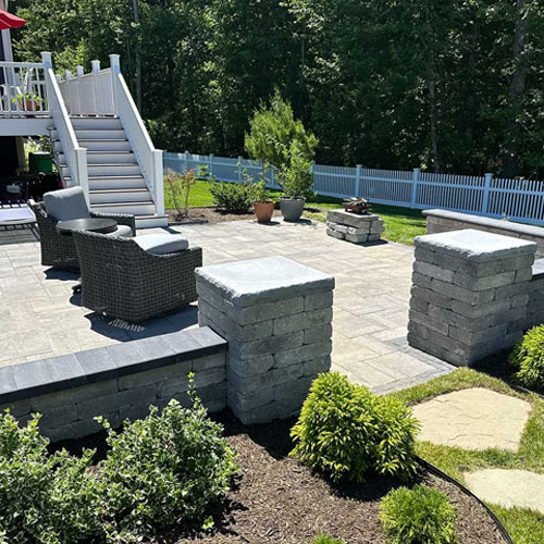 Paver patio and stone seat walls built by IVE Landscaping