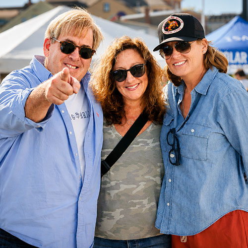 Event photography of three friends at an outdoor festival