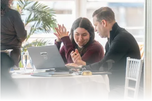 Recruiting Power - Business Owners Collaborating on Laptops