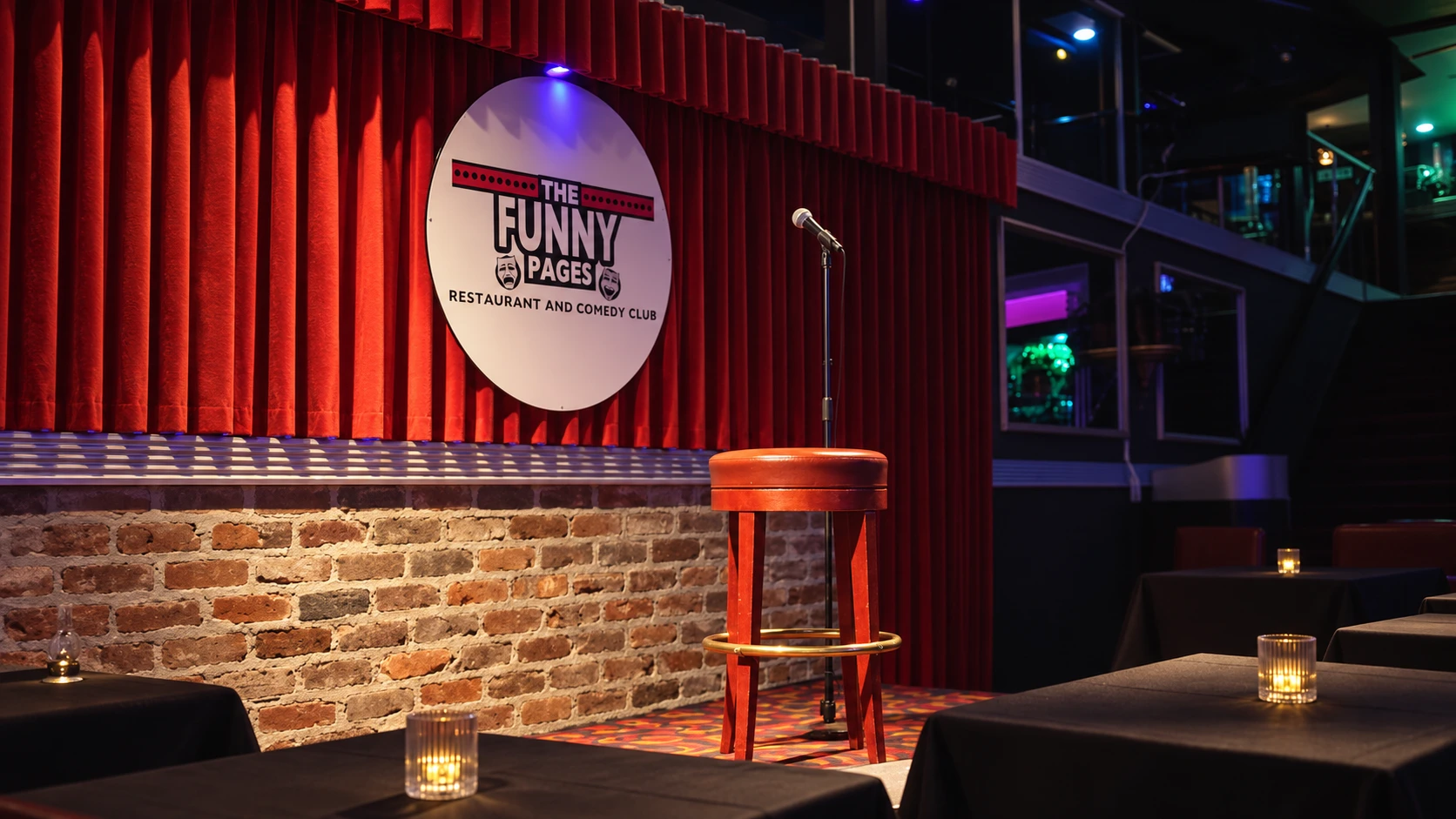 AI-enhanced recreation of The Funny Pages stage: red curtains, round logo sign, exposed brick and wooden stool