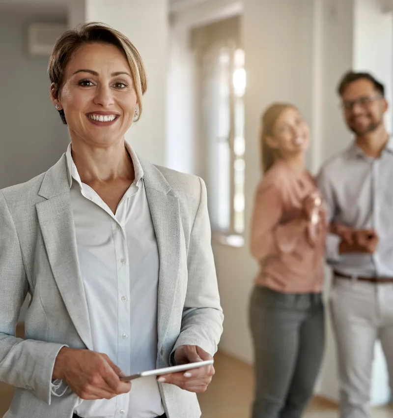 Real estate professional smiling with happy homebuyers