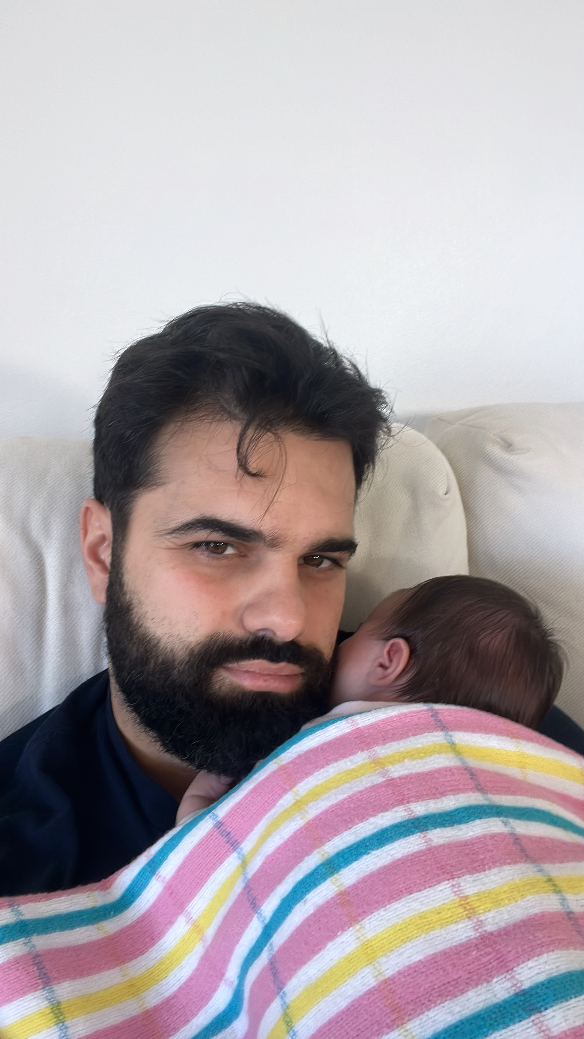 Father holding sleeping baby