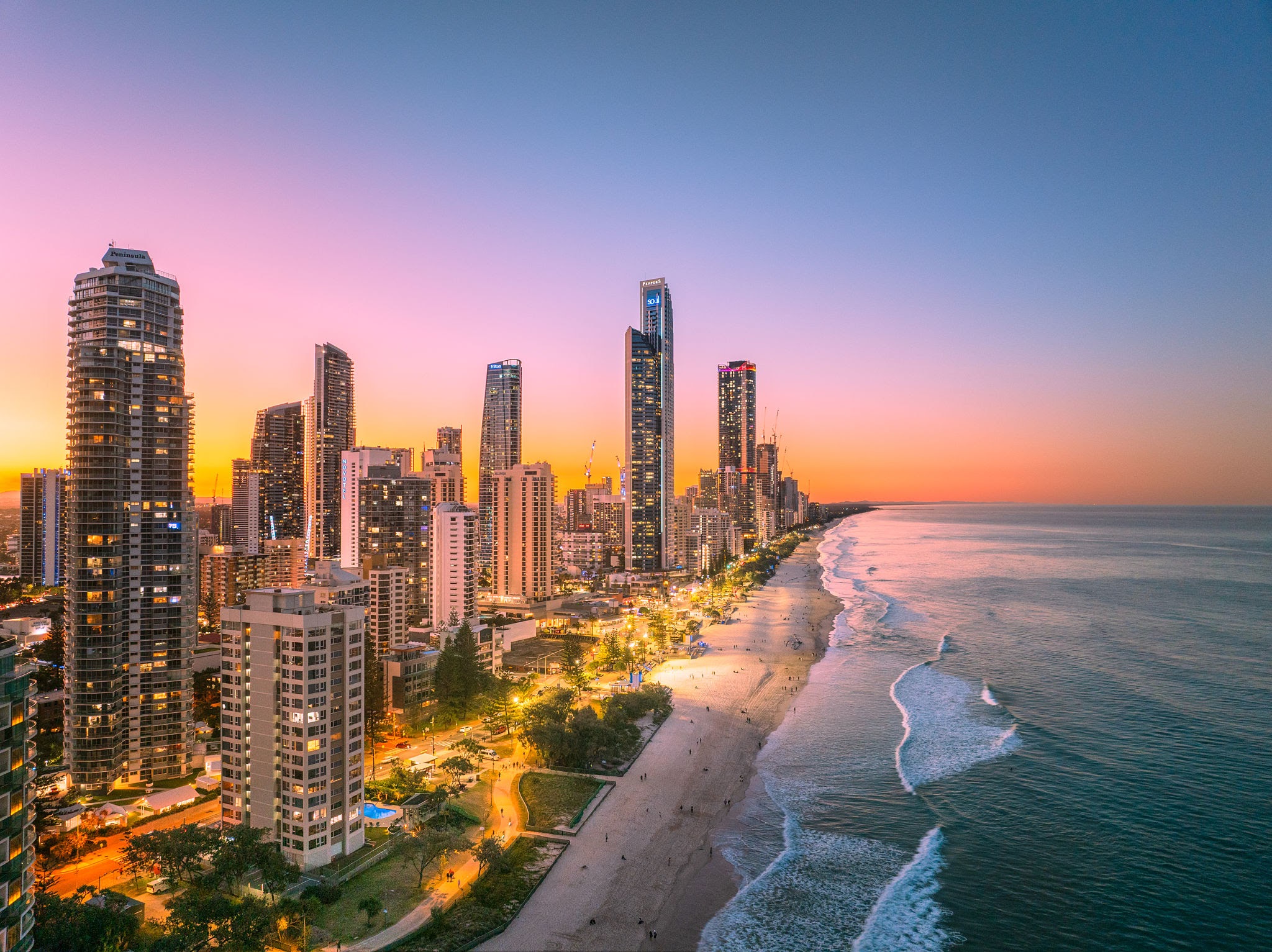 Surfers Paradise beach, ocean and illuminated skyline at dusk