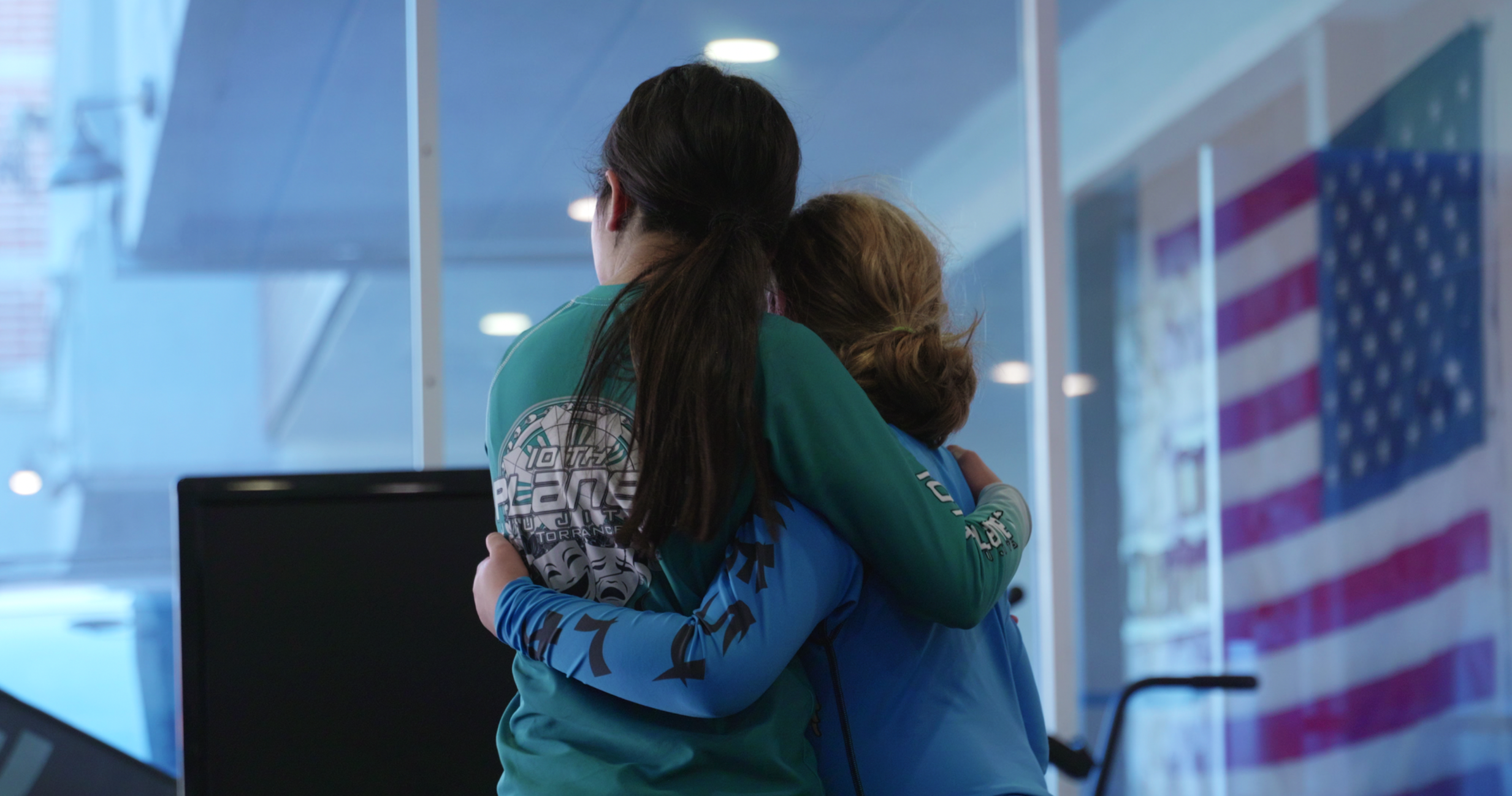 Young 10th Planet Torrance grapplers embracing in support on the mat