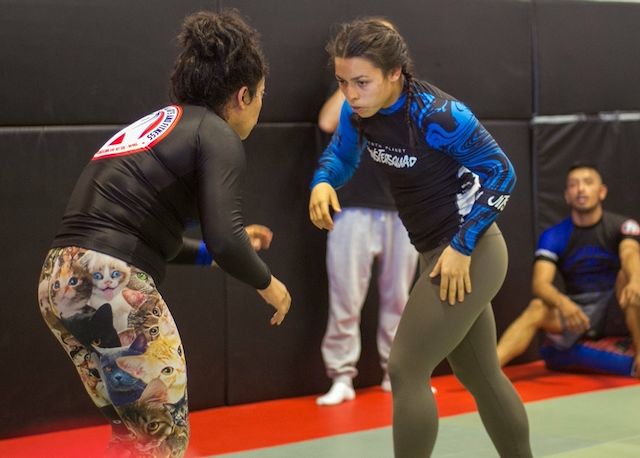 Kirsten in a live competition match standing face to face with opponent