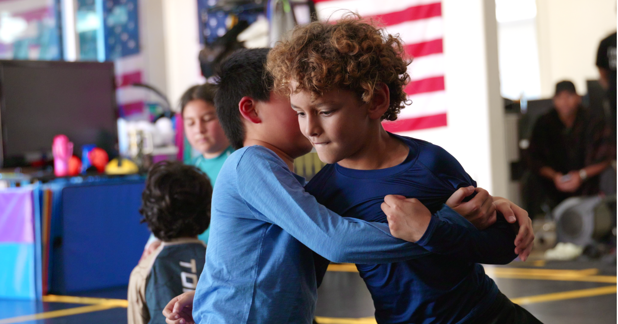 Young students working underhook clinch and body positioning