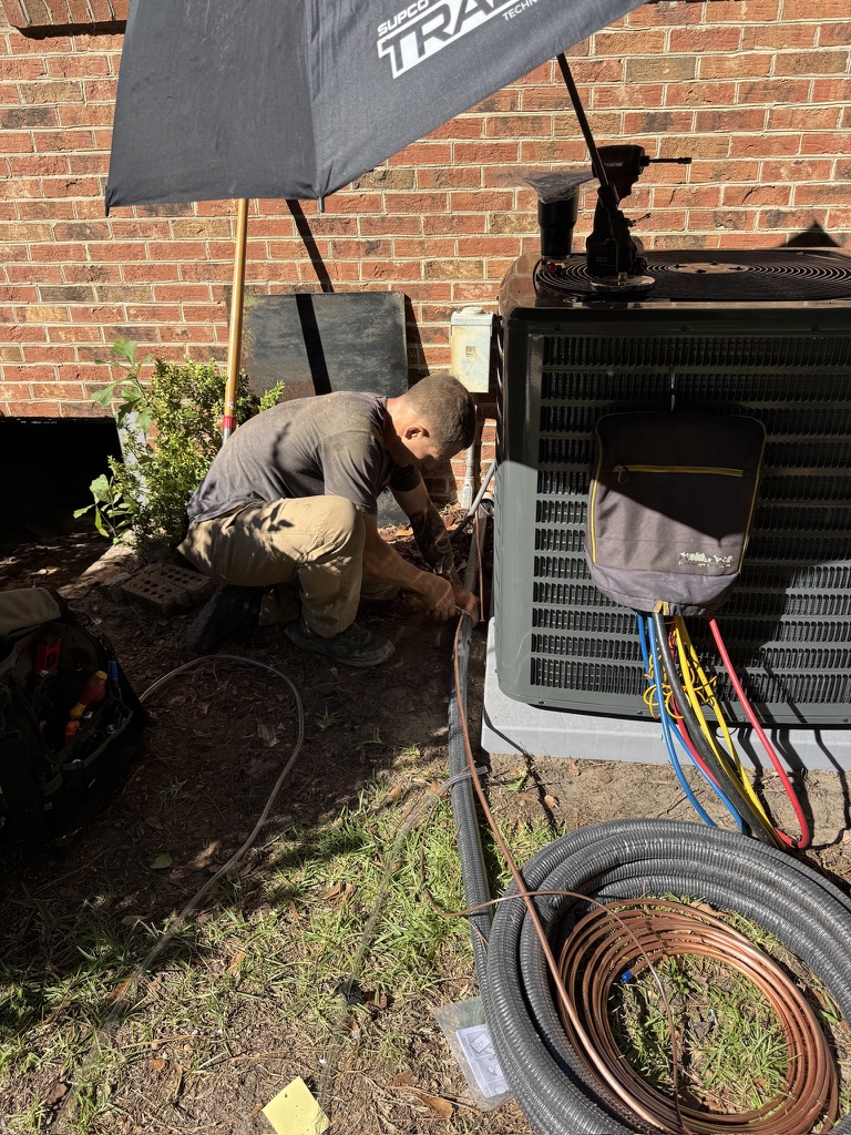 Mike Abbott connecting refrigerant lines during an HVAC installation