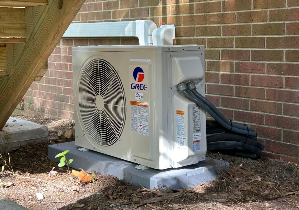 GREE ductless mini-split outdoor unit installed beside a brick home in Sanford, NC.