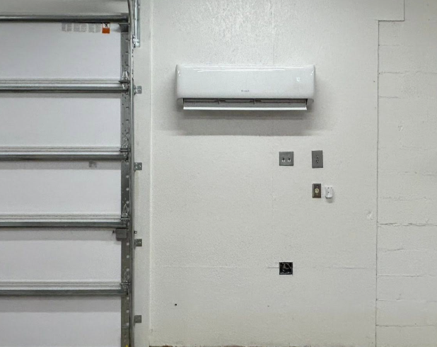 Wall-mounted ductless mini-split indoor unit in a garage in Moore County, NC.