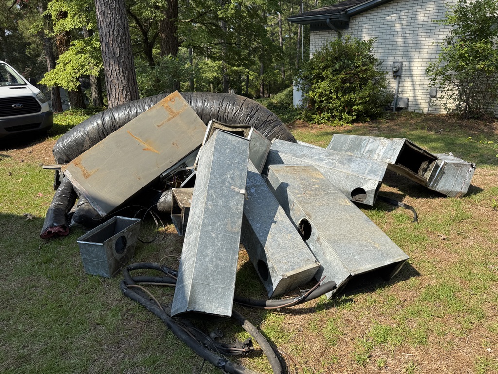 Old metal HVAC ductwork removed during a residential ductwork replacement project in Whispering Pines, NC.