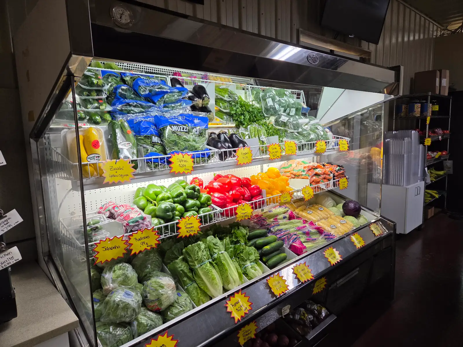 Inside Sap's Produce Shack market featuring fresh refrigerated produce displays