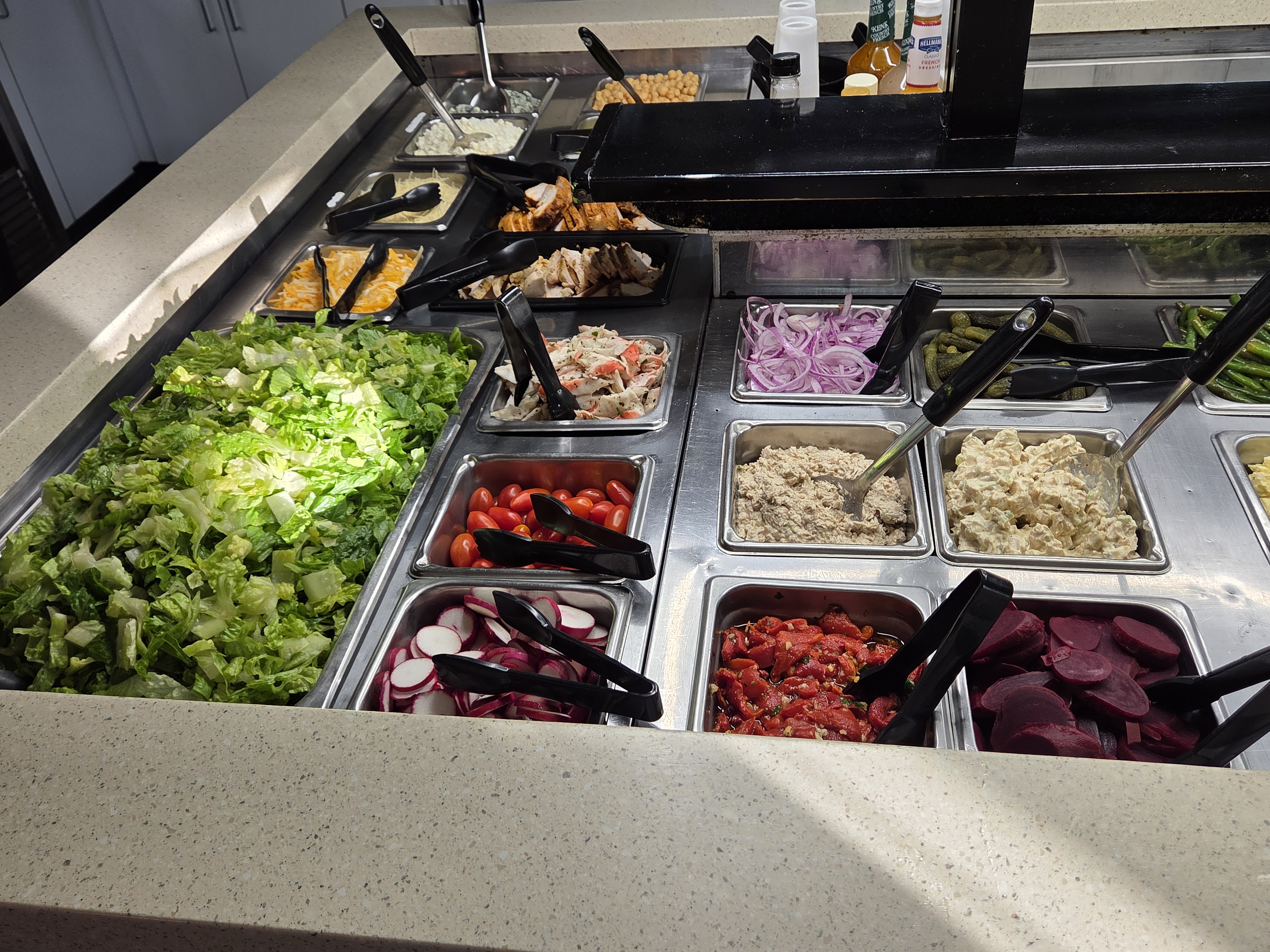 Fresh greens, toppings, and deli proteins at Sap's