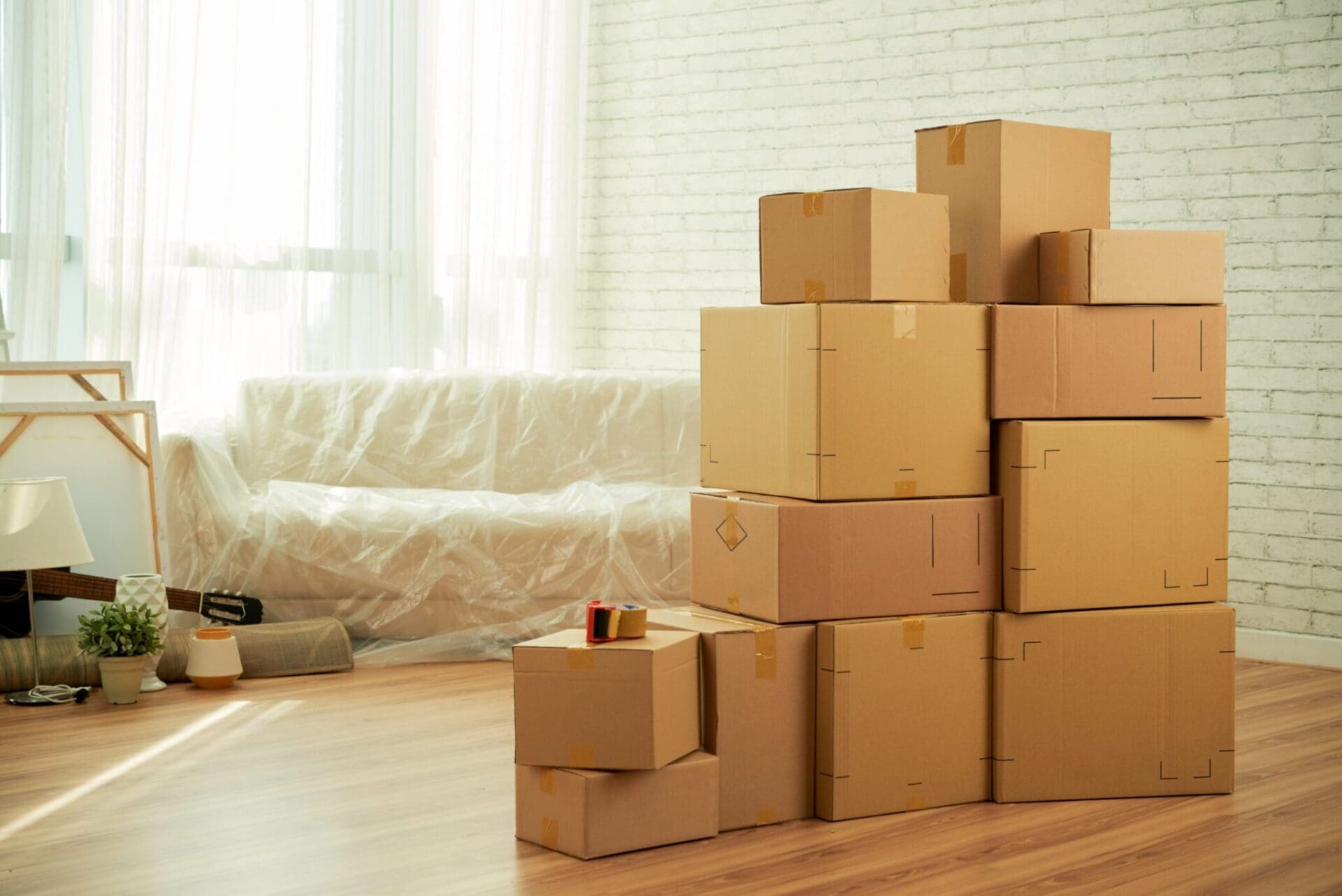 shot-room-interior-with-package-boxes-standing-middle-sofa-covered-with-film-scaled