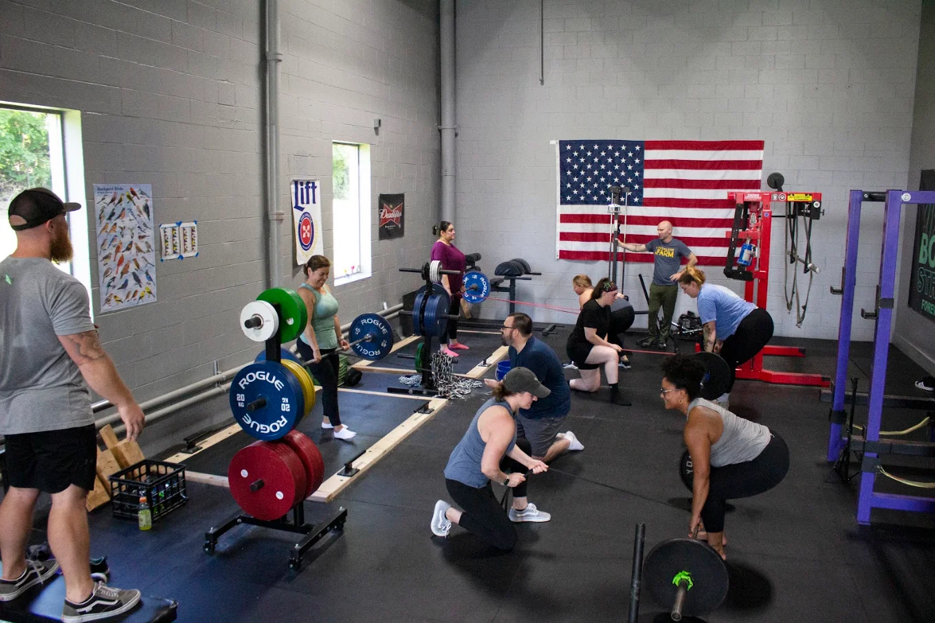 Members deadlifting and barbell training inside Bonvec Strength facility