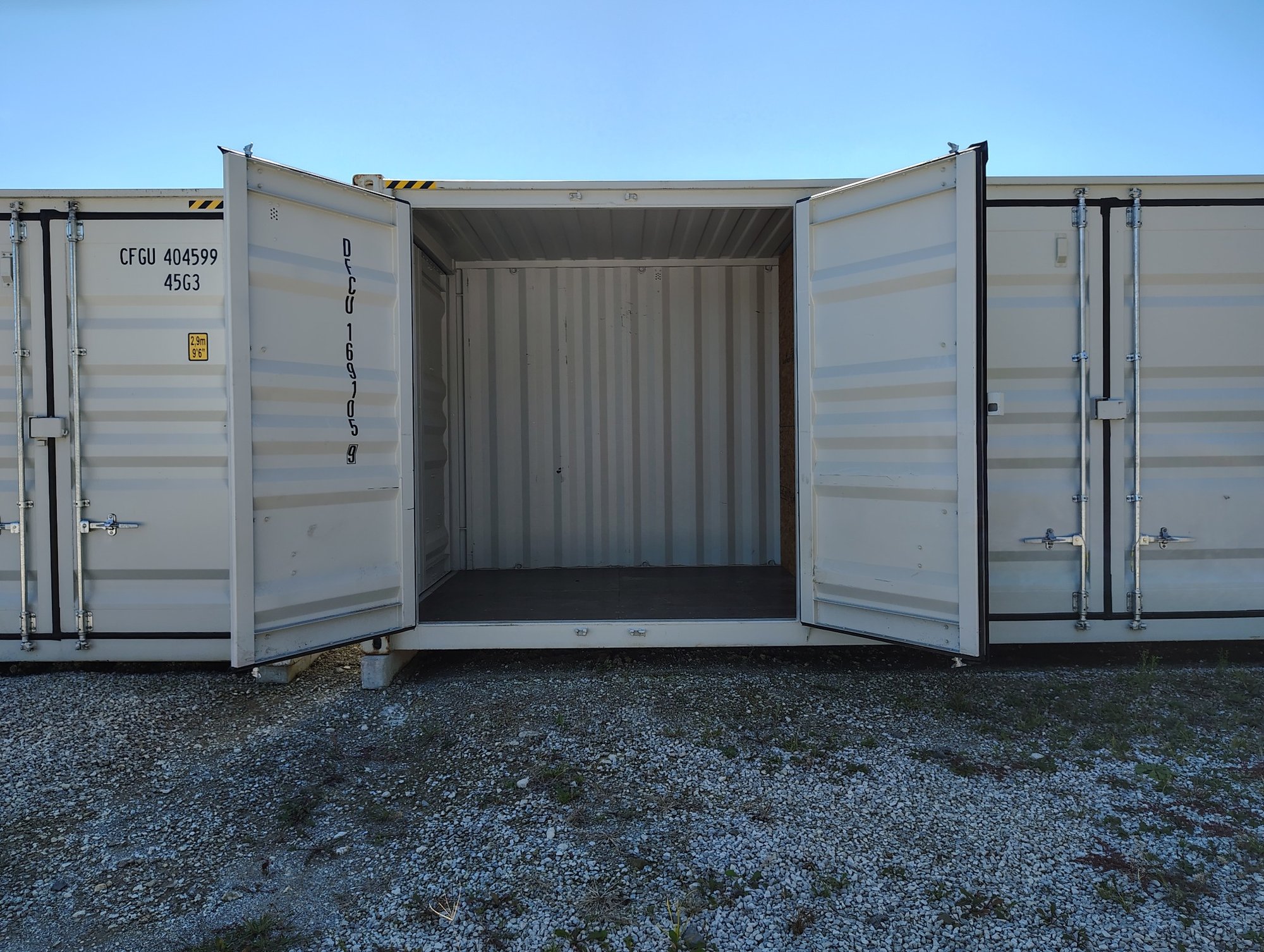 Storage unit with double doors swung open showing access into the unit