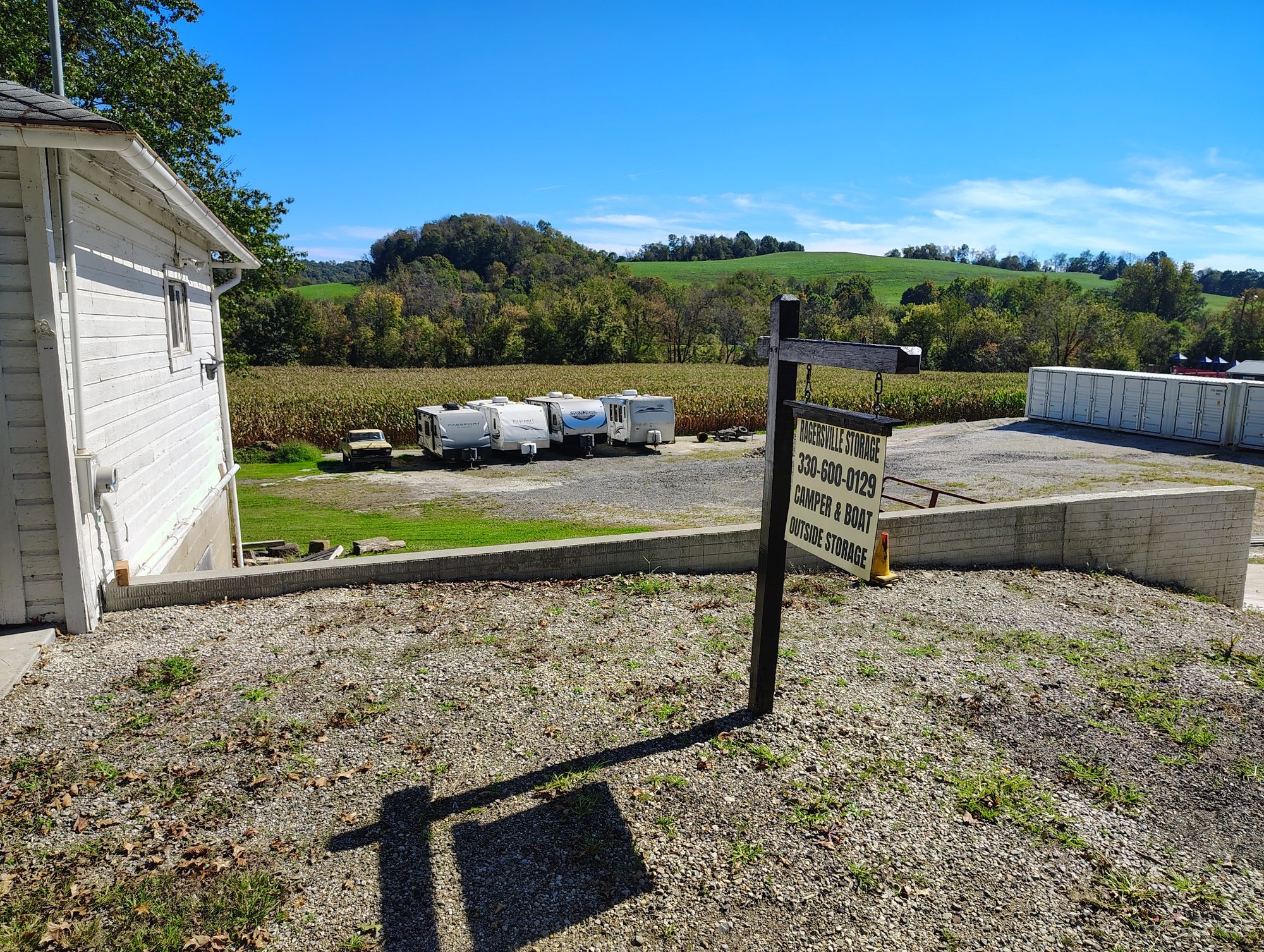 Front view showing Ragersville Storage sign, outdoor camper storage, and rural countryside hills