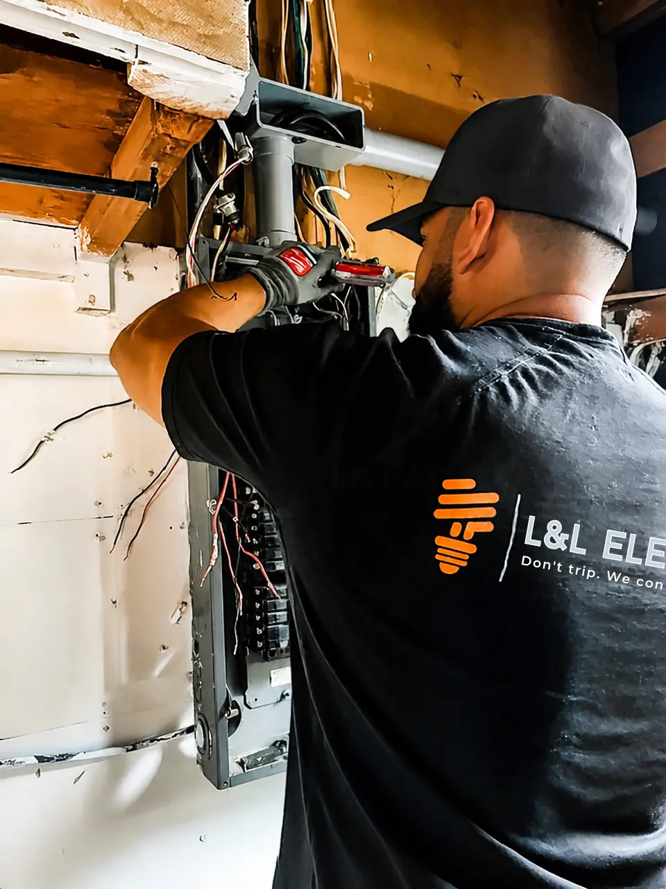 L&L Electric electrician working inside a breaker panel