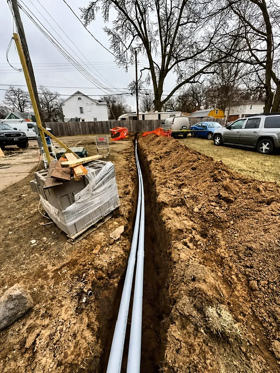 Underground conduit trench on a job site with temporary power