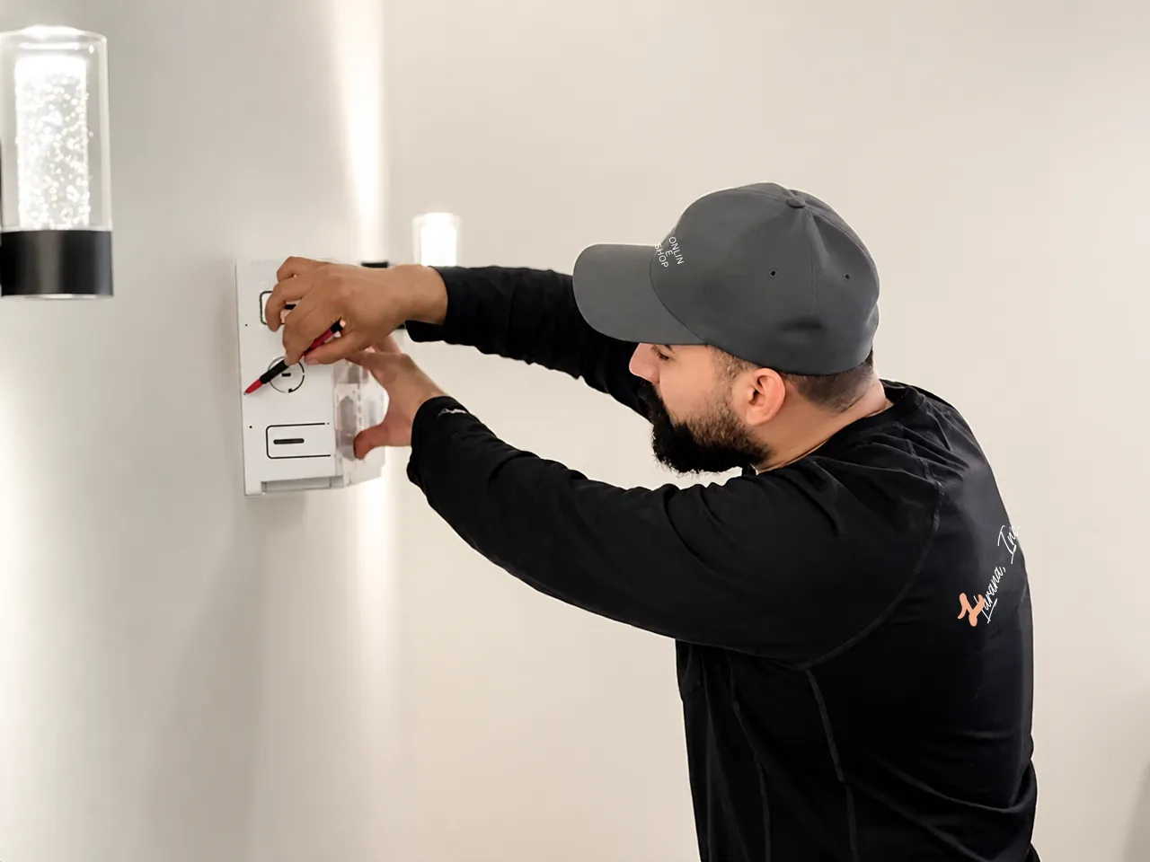 Marvin of L&L Electric installing a wall control in a finished home